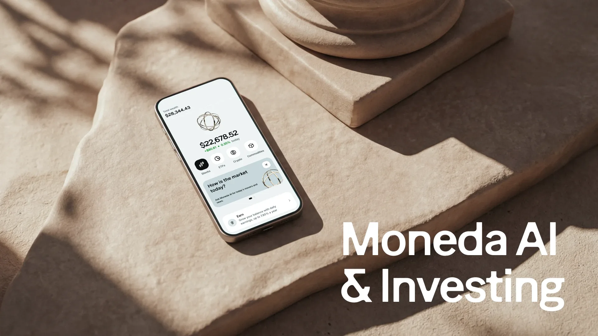 A phone showing the Moneda app home screen with total wealth, investment categories and an Ask Moneda AI card, lying on sunlit stone